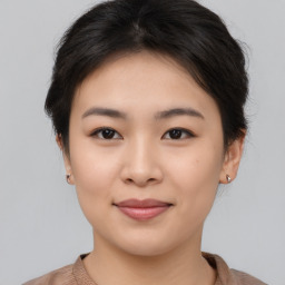 Joyful asian young-adult female with short  brown hair and brown eyes