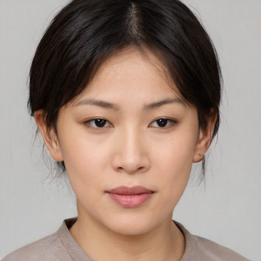 Neutral asian young-adult female with medium  brown hair and brown eyes