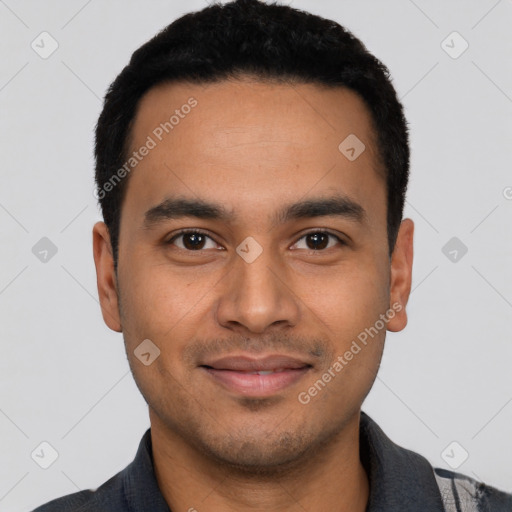Joyful latino young-adult male with short  black hair and brown eyes