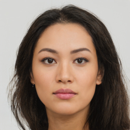 Neutral latino young-adult female with long  brown hair and brown eyes
