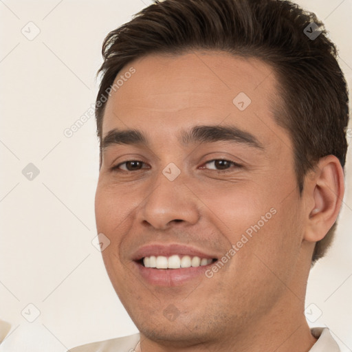 Joyful white young-adult male with short  brown hair and brown eyes