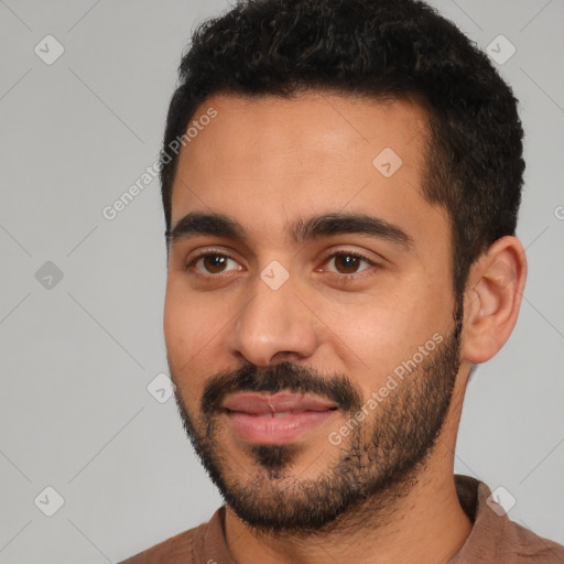 Joyful latino young-adult male with short  black hair and brown eyes