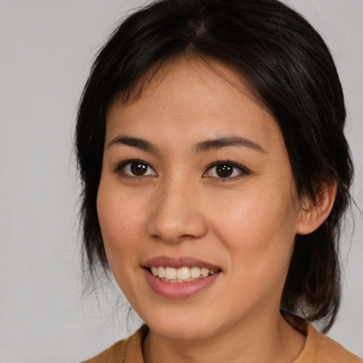 Joyful latino young-adult female with medium  brown hair and brown eyes