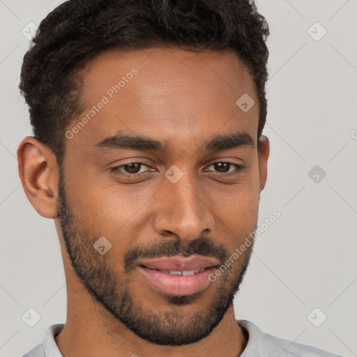 Joyful black young-adult male with short  brown hair and brown eyes