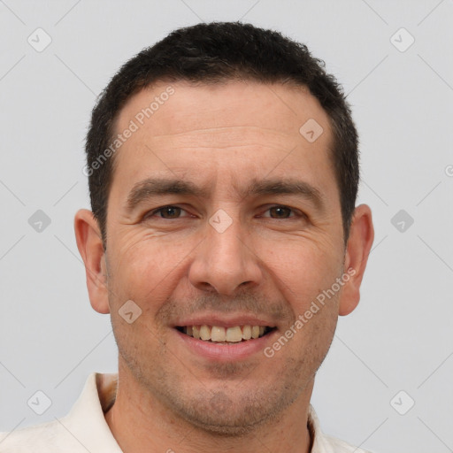 Joyful white adult male with short  brown hair and brown eyes