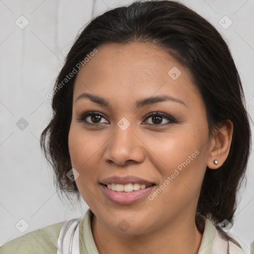 Joyful latino young-adult female with medium  brown hair and brown eyes