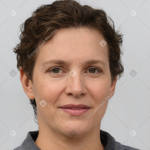 Joyful white adult female with short  brown hair and grey eyes