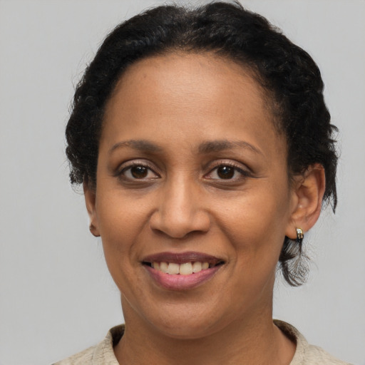 Joyful latino adult female with short  brown hair and brown eyes