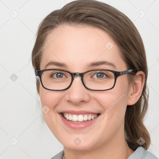 Joyful white young-adult female with medium  brown hair and grey eyes