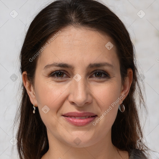 Joyful white adult female with long  brown hair and brown eyes