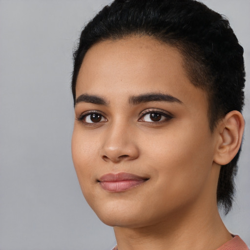 Joyful latino young-adult female with short  black hair and brown eyes