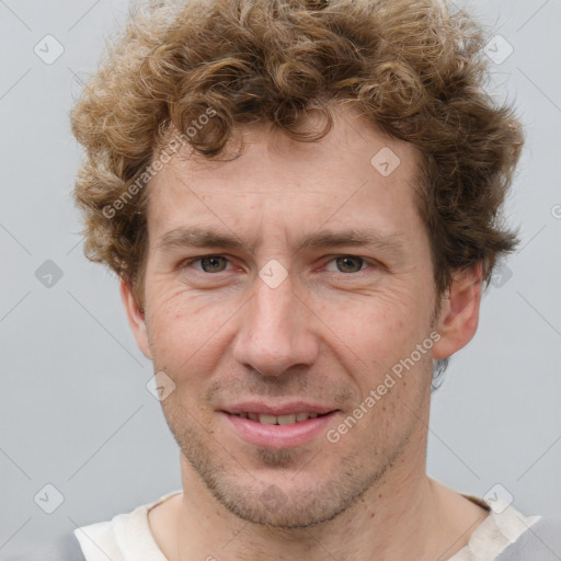 Joyful white adult male with short  brown hair and grey eyes