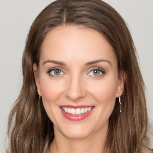 Joyful white young-adult female with long  brown hair and green eyes