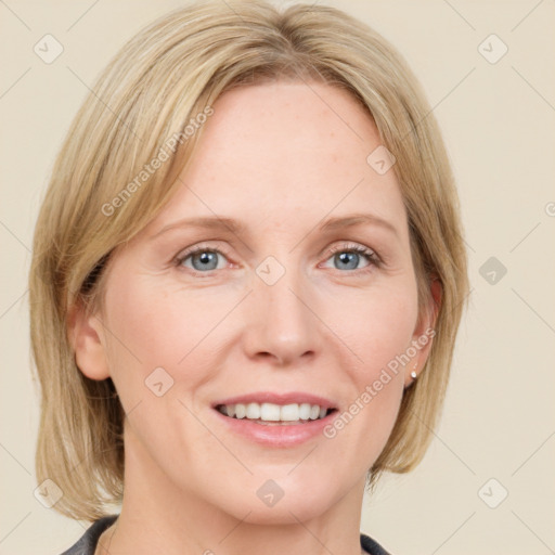 Joyful white adult female with medium  brown hair and blue eyes