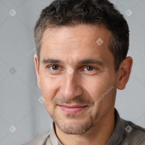 Joyful white adult male with short  brown hair and brown eyes