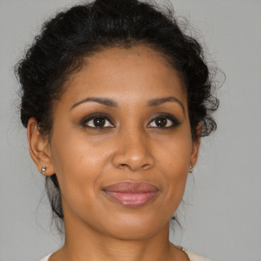 Joyful black young-adult female with medium  brown hair and brown eyes