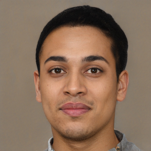 Joyful latino young-adult male with short  black hair and brown eyes