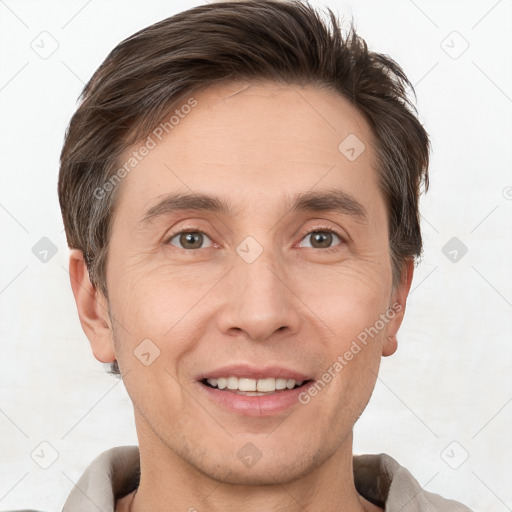 Joyful white adult male with short  brown hair and brown eyes