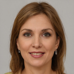 Joyful white young-adult female with long  brown hair and green eyes