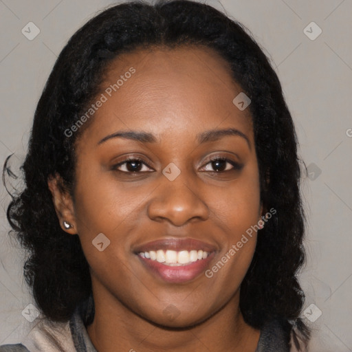 Joyful black young-adult female with long  black hair and brown eyes