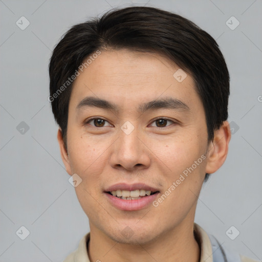 Joyful asian young-adult male with short  brown hair and brown eyes