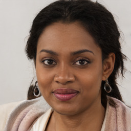 Joyful black young-adult female with long  brown hair and brown eyes