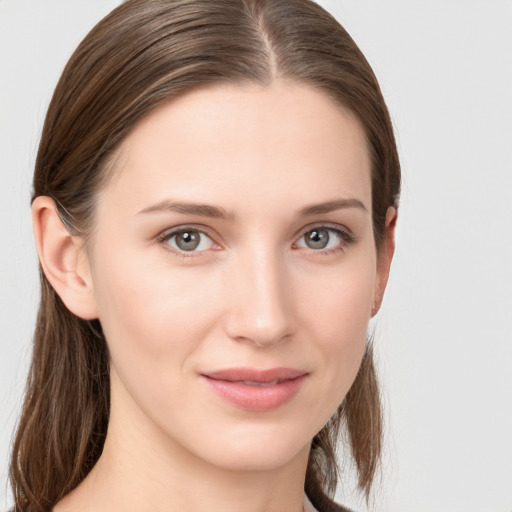 Joyful white young-adult female with long  brown hair and grey eyes