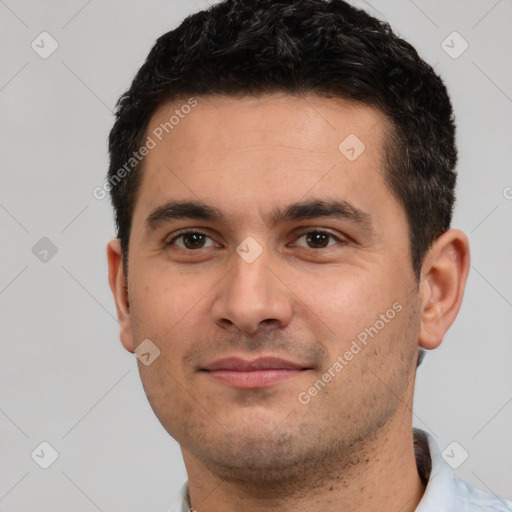 Joyful white young-adult male with short  black hair and brown eyes