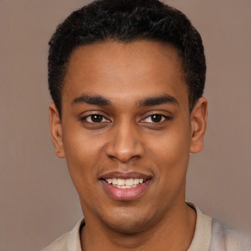 Joyful black young-adult male with short  black hair and brown eyes
