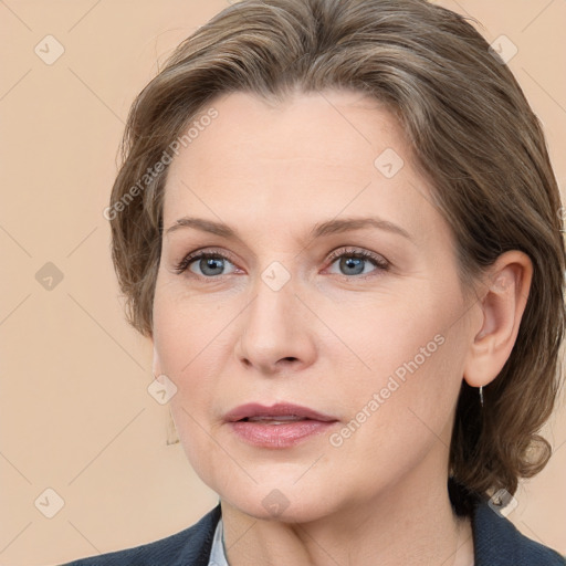 Joyful white adult female with medium  brown hair and grey eyes