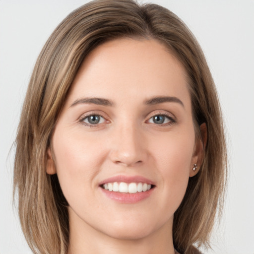 Joyful white young-adult female with long  brown hair and green eyes