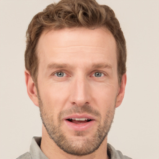 Joyful white adult male with short  brown hair and grey eyes