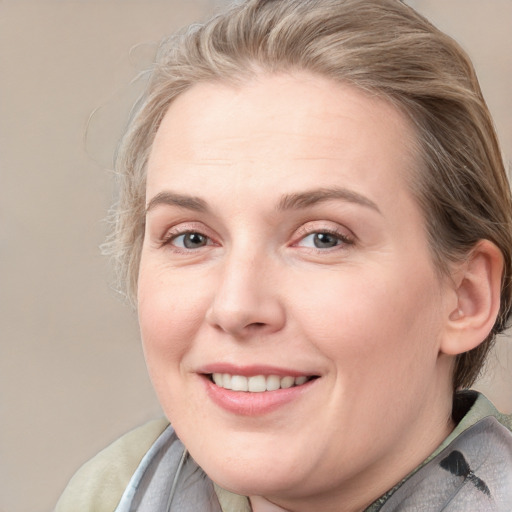 Joyful white adult female with medium  brown hair and blue eyes