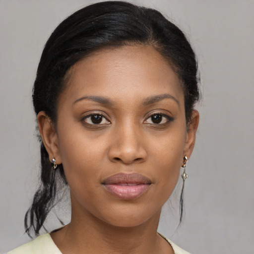 Joyful black young-adult female with medium  brown hair and brown eyes