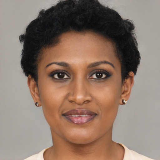 Joyful black young-adult female with short  brown hair and brown eyes