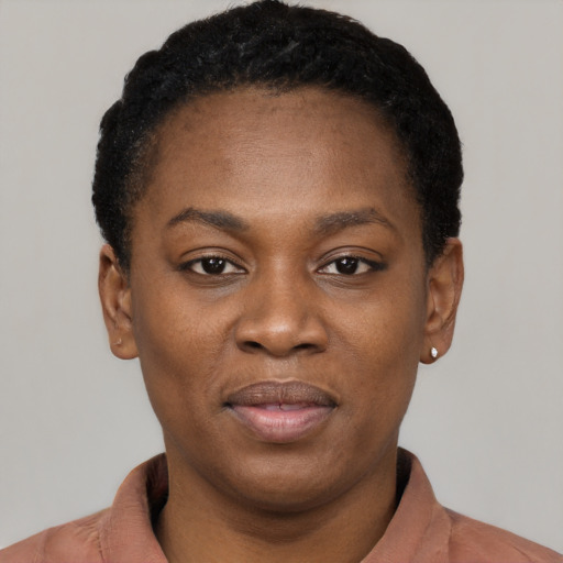 Joyful black adult female with short  black hair and brown eyes
