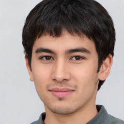 Joyful asian young-adult male with short  brown hair and brown eyes