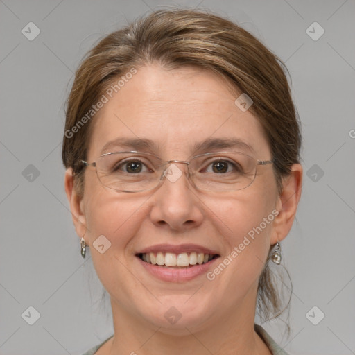 Joyful white adult female with medium  brown hair and grey eyes