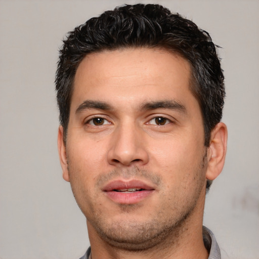 Joyful white young-adult male with short  black hair and brown eyes