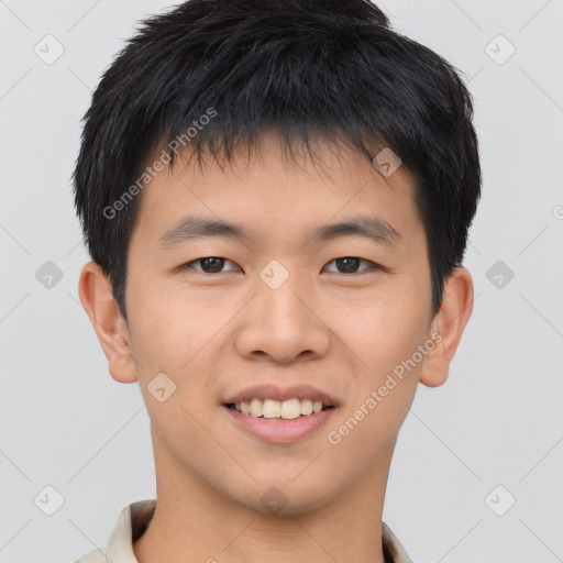 Joyful asian young-adult male with short  brown hair and brown eyes