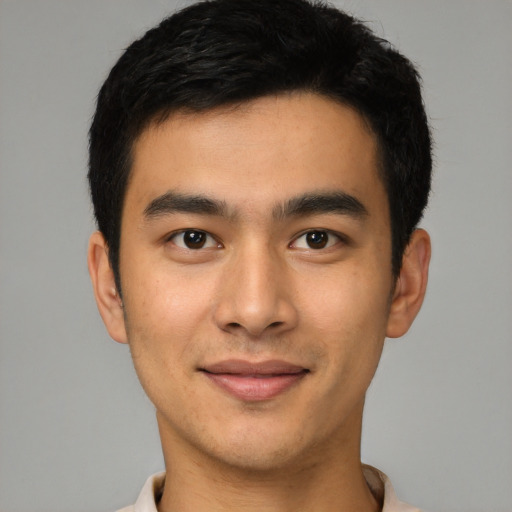 Joyful latino young-adult male with short  brown hair and brown eyes