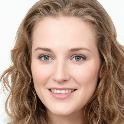 Joyful white young-adult female with long  brown hair and blue eyes