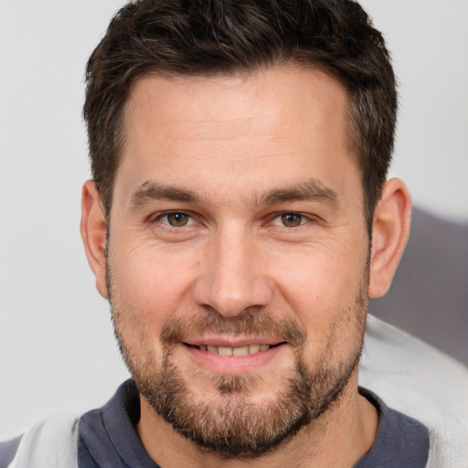 Joyful white adult male with short  brown hair and brown eyes