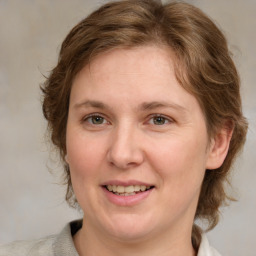 Joyful white young-adult female with medium  brown hair and blue eyes