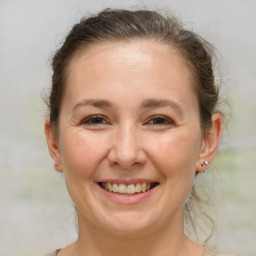 Joyful white adult female with medium  brown hair and brown eyes