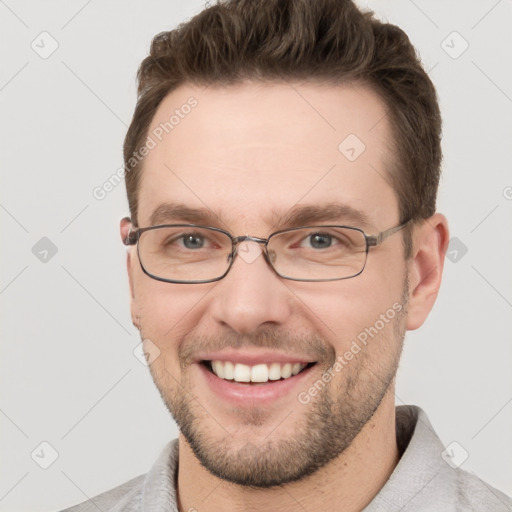 Joyful white young-adult male with short  brown hair and grey eyes