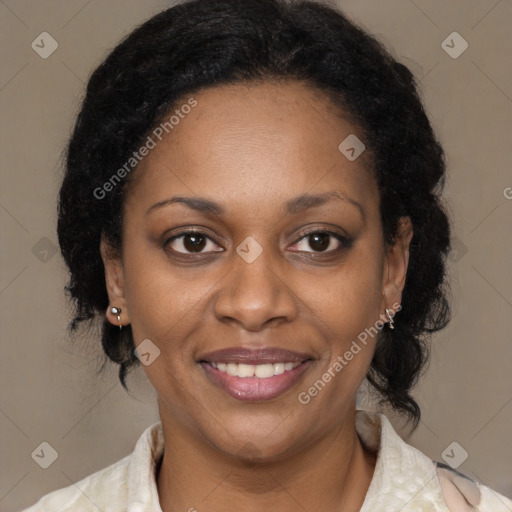 Joyful black adult female with medium  brown hair and brown eyes