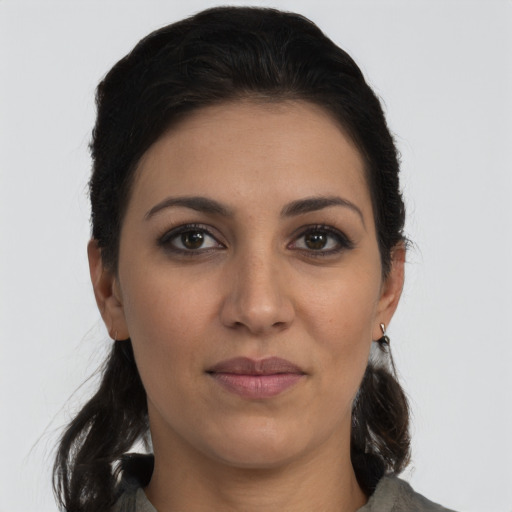 Joyful latino young-adult female with long  brown hair and brown eyes