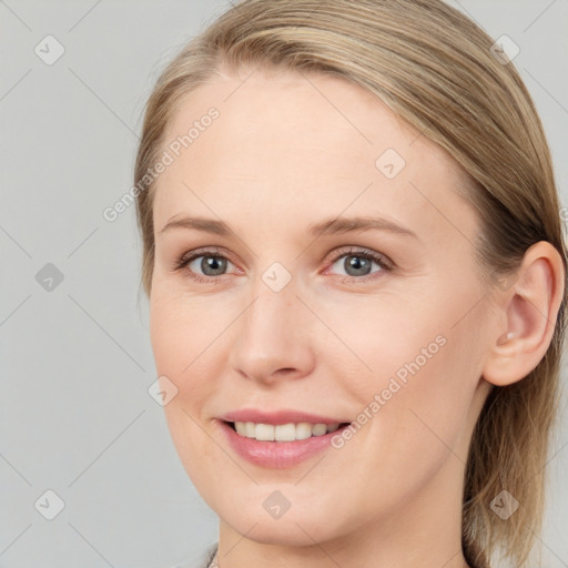 Joyful white young-adult female with long  brown hair and blue eyes