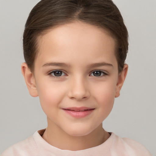 Joyful white child female with short  brown hair and brown eyes